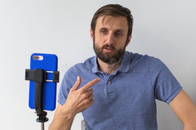 Smartphone on a tripod recording a content creator, with TikTok and YouTube icons symbolizing social media monetization, expressing side hustles that work well in a tough economy .